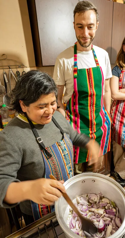 Teacher guiding a student through cooking onions